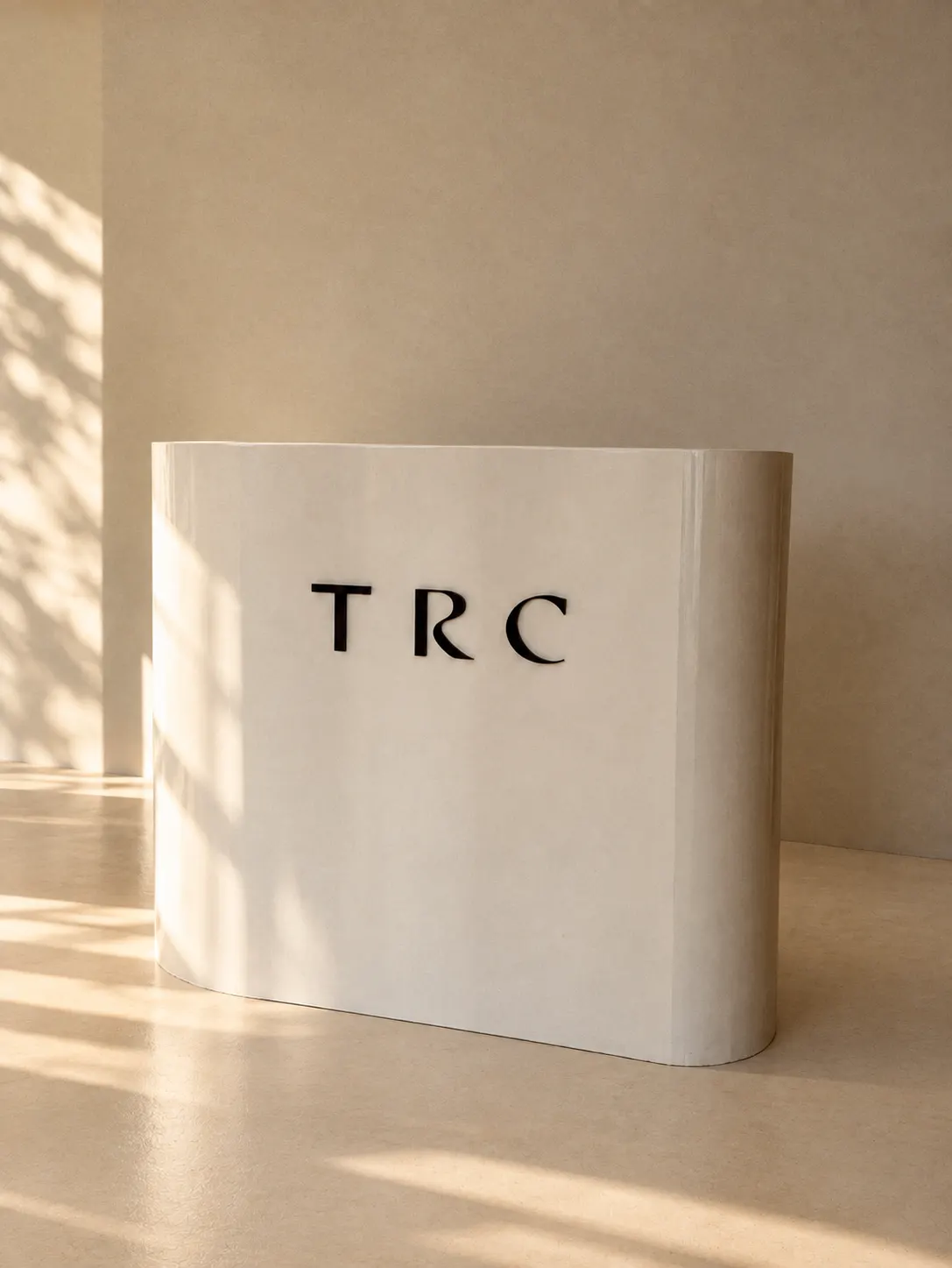 TRC lettering on the curved plaster reception desk